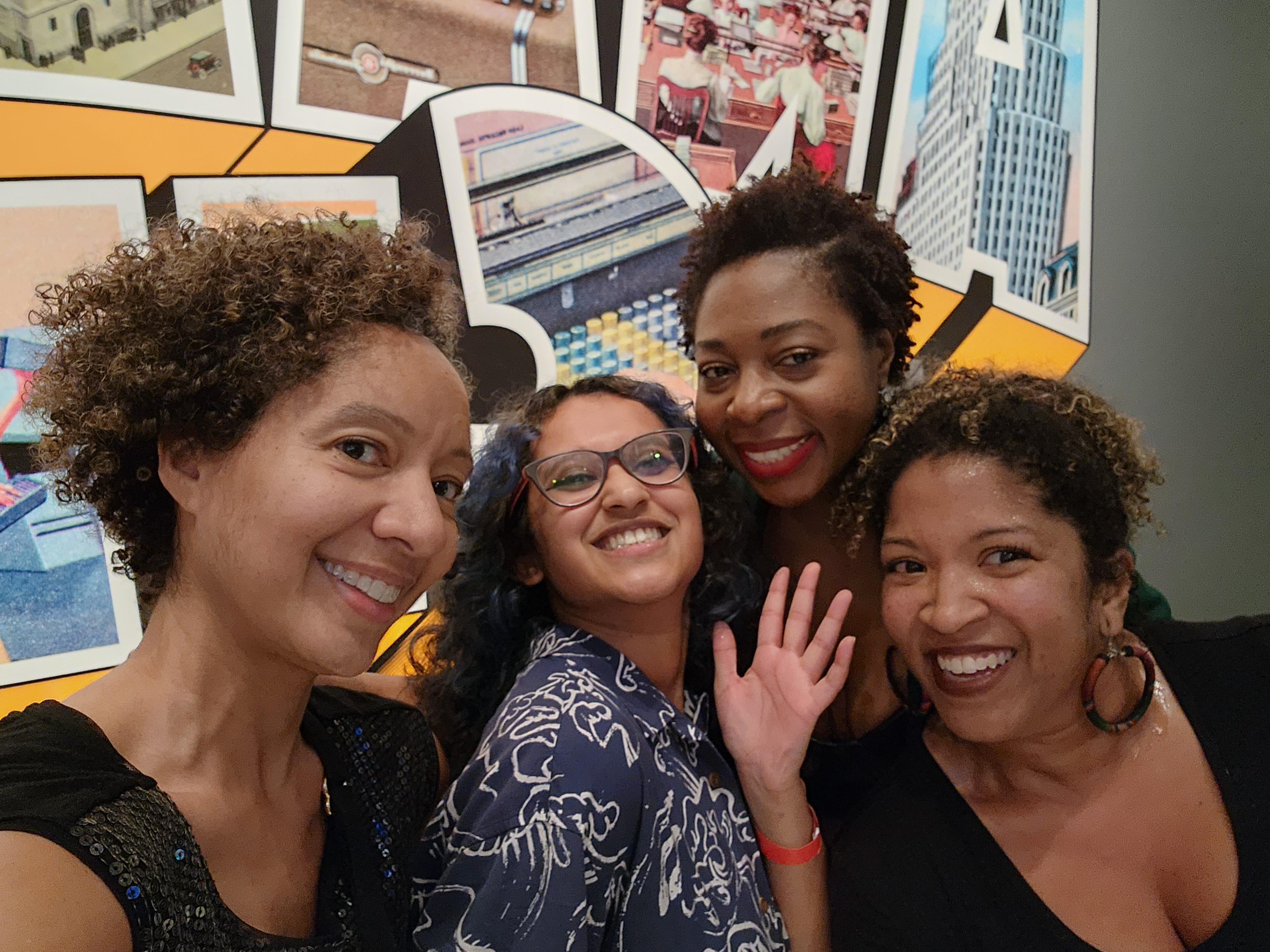 Four women pose towards the camera.